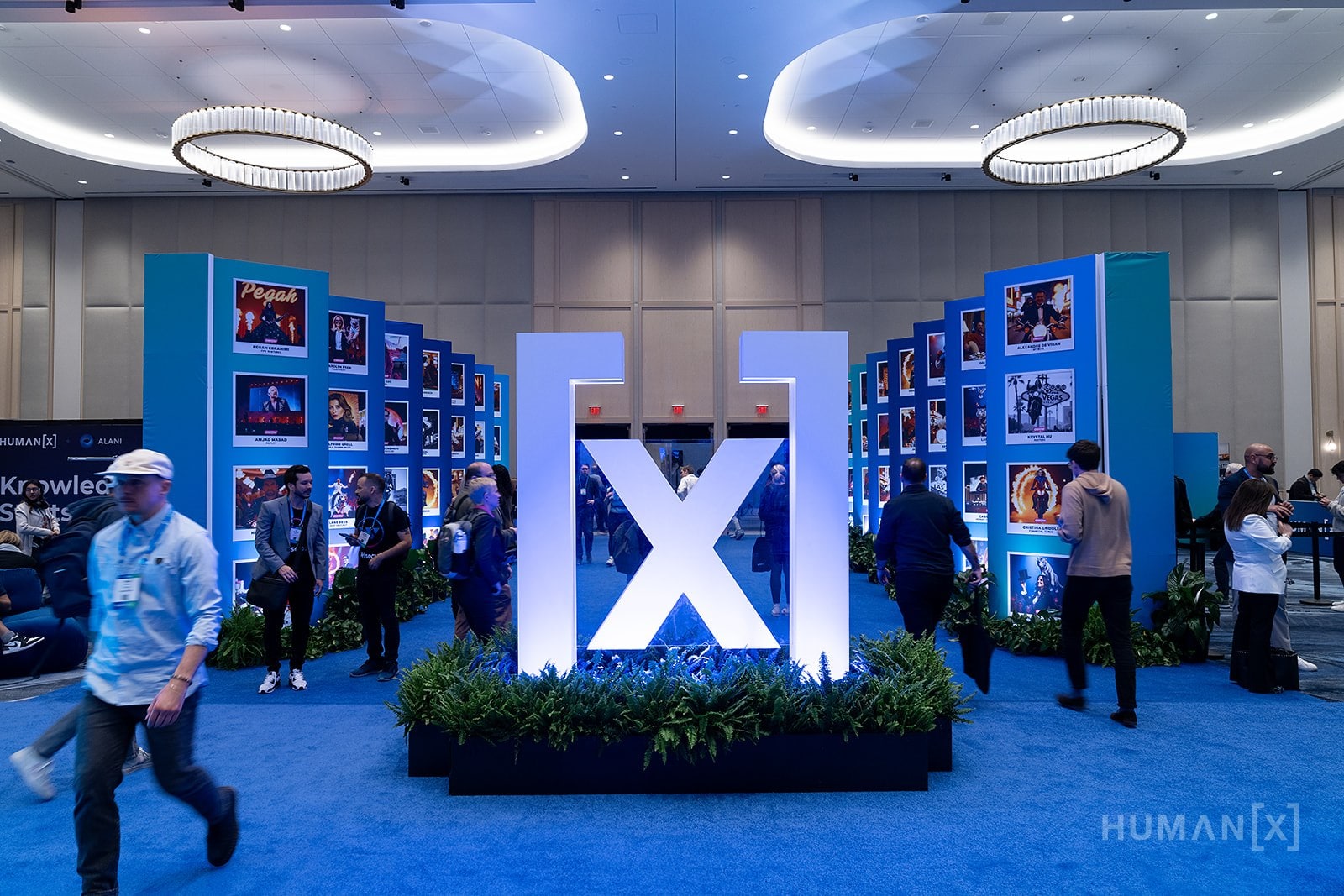 Attendees walking past the HumanX brand installation in the expo hall.